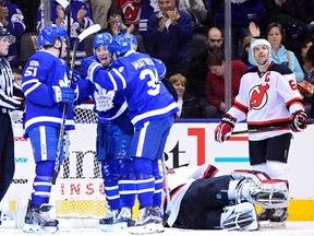 Toronto Maple Leafs left wing Josh Leivo (32) celebrates his goal against New Jersey Devils goalie Keith Kinkaid (1) with teammates Jake Gardiner (51) and Auston Matthews (34) as New Jersey Devils defenceman Andy Greene (6) looks on during first period NHL action in Toronto on Thursday, March 23, 2017. THE CANADIAN PRESS/Frank Gunn