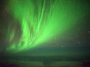 The Southern Lights are seen over the Southern Ocean near Antarctica from a chattered plane Friday, March 24, 2017. A charter plane that left Dunedin, New Zealand, late Thursday flew close to the Antarctic Circle to give the eager passengers an up-close look at the Aurora Australis, or Southern Lights. (Ian Griffin via AP)