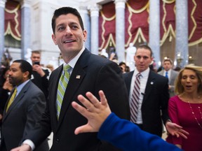 House Speaker Paul Ryan of Wisc., passes a waving tourist as he walks from the House Chamber to his office on Capitol Hill in Washington, Friday, March 24, 2017, as the House nears a vote on their health care overhaul. (AP Photo/Cliff Owen)