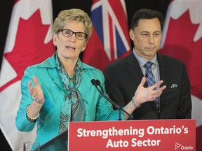 Ontario Premier Kathleen Wynne and Minister Brad Duguid hold a press conference after meeting with key auto industry leaders in Toronto on Friday March 24, 2017. (Stan Behal/Toronto Sun)