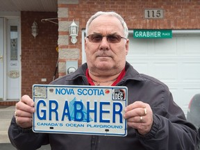 Lorne Grabher displays his personalized licence plate in Dartmouth, N.S. on Friday, March 24, 2017. The Nova Scotia government has withdrawn a man's eponymous personalized licence plate, saying Lorne Grabher's surname is offensive to women. THE CANADIAN PRESS/Andrew Vaughan