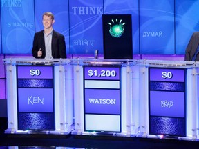 A year after IBM began teaching its Watson computer system to fight cybercrime, the company is making the platform available for use. In this Jan. 13, 2011, file photo, "Jeopardy!" champions Ken Jennings, left, and Brad Rutter, right, look on as the IBM computer called "Watson" beats them to the buzzer to answer a question during a practice round of the "Jeopardy!" quiz show in Yorktown Heights, New York. THE CANADIAN PRESS/AP-Seth Wenig