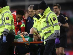 Ireland's Seamus Coleman is taken off the pitch injured during their 2018 World Cup Group D qualifying soccer match against Wales at the Aviva Stadium, Dublin, Ireland, on Friday, March 24, 2017. (Brian Lawless/PA via AP)