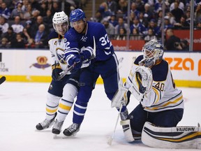 Sabres' Justin Falk (left) and Maple Leafs' Josh Leivo (centre) battle in front of Sabres goalie Robin Lehner during NHL action in Toronto on Feb. 11, 2017. (Michael Peake/Toronto Sun)