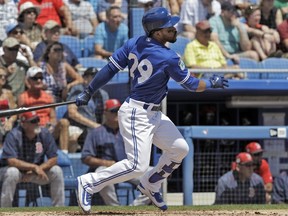 Blue Jays' Devon Travis hits an RBI double off Boston Red Sox starting pitcher Drew Pomeranz during the second inning in Dunedin yesterday. It was Travis’ first game action of the spring. The Blue Jays won 3-2. (Chris O'Meara/AP Photo)