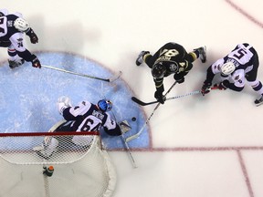 JJ Piccinich of the Knights works in tight on Michael DiPietro of the Spitfires while being checked by Austin McEneny of the Spits while Sean Day covers the slot during the first period of their playoff game at Budweiser Gardens on Friday March 24, 2017. (MIKE HENSEN, The London Free Press)