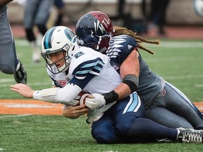 Argonauts quarterback Drew Willy is tackled by Alouettes' Bear Woods during second half CFL action in Montreal on Oct. 2, 2016. (Graham Hughes/The Canadian Press/Files)
