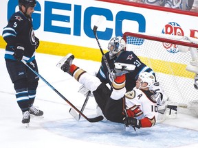 Playoff flashback: The Jets’ Mark Stuart (left) knocks down the Ducks’ Corey Perry in front of goaltender Ondrej Pavelec in Game 4 of their first-round series. Winnipeg didn’t win a single game and haven’t made it back to the post-season since.(Getty Images file)
