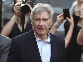 In this Dec. 10, 2015 file photo, Harrison Ford greets fans during a Star Wars fan event in Sydney, Australia. (AP Photo/Rob Griffith, File)