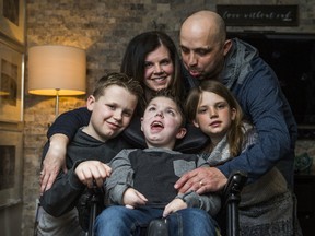 Joshua Bastin, 11, who suffers from congenital muscular dystrophy, poses with his family at their home in Cambridge, Ont. on Friday March 24, 2017. The Bastin family - using gofundme.com - are raising money for a motorhome so they can do a memorable roadtrip. Mother and father are Jeremy and Charlotte. Siblings are Owen, 14, and sister Kyla, 8. (Ernest Doroszuk/Toronto Sun)