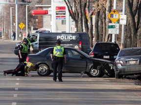 Police continue to investigate at the scene of a serious single vehicle crash along 97 Street north of 116 Avenue, in Edmonton Saturday, March 25, 2017. A woman was taken to hospital in critical condition. Photo by David Bloom