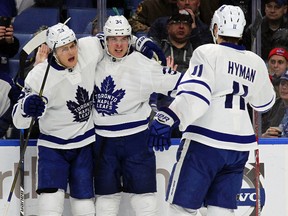 Toronto Maple Leafs rookie Auston Matthews (34) celebrates his goal with teammates William Nylander (29) and Zach Hyman (11) Saturday, March 25, 2017, in Buffalo, N.Y. (AP Photo/Jeffrey T. Barnes)