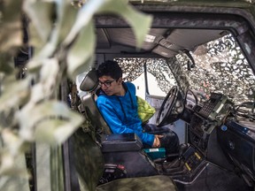 Avi Toor looks inside the Mercedes armoured transport truck. There was an Open House at the Philip L. Debney Armoury highlighting 41 Canadian Brigade Group's Made in Alberta recruiting initiative with over 50 recruits. They were looking at all the jobs offered by the unit  on March 25, 2017.  Photo by Shaughn Butts / Postmedia
