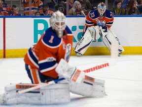 Edmonton Oilers goaltender Cam Talbot (33) watches backup Laurent Brossoit (1) take part in the pre-game warmup against the Colorado Avalanche at Rogers Place in Edmonton on Saturday, March 25, 2017. (David Bloom)