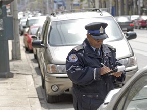 Unidentifed parking enforcement officer hands out a ticket. Toronto Sun files