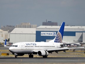 In this Sept. 8, 2015 file photo, a United Airlines passenger plane lands at Newark Liberty International Airport in Newark, N.J. (AP Photo/Mel Evans)