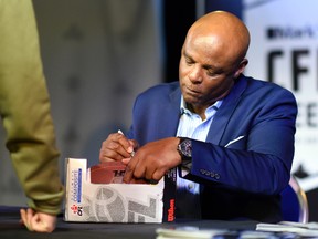 Football legend Warren Moon signs autographs during CFL Week in Regina. (TROY FLEECE/Postmedia Network)