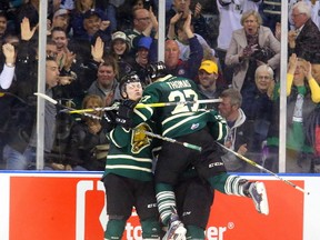 Max Jones of the Knights makes the score 4-2 with an empty netter and is congratulated by linemates Cliff Pu, and Robert Thomas late in the third period of their playoff game on Sunday March 26, 2017 at Budweiser Gardens. Max Jones added another empty netter to make the score 5-2. Mike Hensen/The London Free Press/Postmedia Network