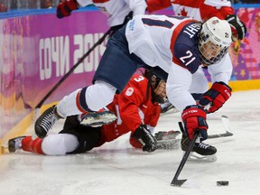 In this Feb. 20, 2014, file photo, United States’ Hilary Knight passes the puck against Canada at the Winter Olympics in Sochi, Russia. (AP Photo/Mark Humphrey, File)