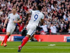 England’s Jermain Defoe turns around after scoring during a World Cup  qualifying match against Lithuania at Wembley Stadium on Sunday. England won 2-0. (AP)