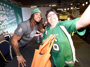 Saskatchewan Roughriders receiver Naaman Roosevelt takes a photo with a fan as part of an autograph session during CFL Week in Regina. (TROY FLEECE/Postmedia Network)