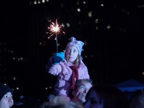 A child holds a sparkler during the Earth Hour 2009 event in Nathan Phillips Square in Toronto. (Postmedia Network files)