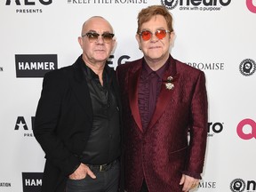 Elton John, right, and Bernie Taupin arrive at Elton John's 70th Birthday and 50-Year Songwriting Partnership with Taupin on Saturday, March 25, 2017 in Los Angeles. (Photo by Jordan Strauss/Invision/AP)