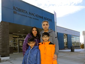 Sushma (left) and Daxesh Dalal (right) and their sons Krishan (9-years-old) and Jayden (11-years-old) outside Roberta MacAdams School in southwest Edmonton where the boys attend school. The family is concerned that there is no proposed new high school for southwest Edmonton, a rapidly growing area of the city. LARRY WONG/POSTMEDIA