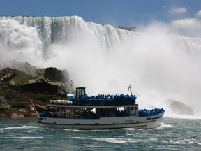 Tourists ride the Maid of the Mist tour boat at the base of the American Falls in Niagara Falls, N.Y. in 2010. (AP Photo/David Duprey, File)