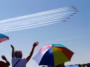 Luke Hendry/Intelligencer file photo
Nancy Turner, Pat Runions and Makayla Turner, all of Campbellford, watch the Snowbirds air demonstration team as the nine pilots wrap up their show at Canadian Forces Base Trenton, June 25, 2016. The photograph resulted in The Intelligencer reporter Luke Hendry being nominated for an Ontario Newspaper Award for feature photography.
