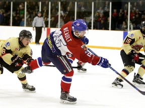 Rayside-Balfour Canadians' Matthew Neault fires a shot while a pair of Blind River Beavers players look on during NOJHL playoff action at Chlemsford Arena on Sunday night. Gino Donato/The Sudbury Star