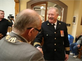 Jason Miller/The Intelligencer 
Mayor Taso Christopher bids farewell to Deputy Chief Ray Ellis who announced his retirement to council Monday.