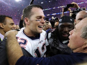 Patriots quarterback Tom Brady (12) celebrates with head coach Bill Belichick after defeating the Falcons in overtime at NFL Super Bowl 51 in Houston on Feb. 5, 2017. Patriots owner Robert Kraft said Monday, March 27, that Brady, 39, is willing to play for another six or seven more years. (David J. Phillip/AP Photo/Files)