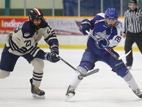 Nik Valliant, right, of the Sudbury Nickel Capital Wolves, battles for the puck with Abdul Abouzeeni, of the Windsor Jr. Spitfires, at the Central Region Midget AAA Championship being held in Sudbury this week. Gino Donato/The Sudbury Star