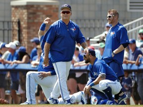 Blue Jays manager John Gibbons shares a laugh with some of his players before the start of a spring training game against the Tigers in Dunedin, Fla., on March 22, 2017. (Chris O'Meara/AP Photo)