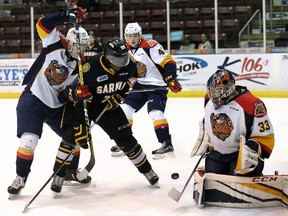 Erie Otters goalie Troy Timpano makes a save in front of Sarnia Sting's Jaden Lindo (22) and Otters' T.J. Fergus in the first period during Game 3 in their OHL Western Conference quarter-final at Progressive Auto Sales Arena in Sarnia on Monday, March 27, 2017. (MARK MALONE, Postmedia Network)