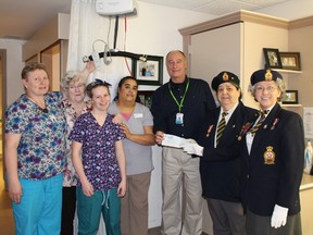 Joyce Rickard Director of Care at Villa Minto holds a patient Ceiling Lift like the one that will be purchased from the $7880. cheque donated from the Legion. Included in the presentation were Pat Dorff LMH Chair, Kayla Plamondon PSW Student, Lucy Toal PSW, Paul Chatelaine CEO of LMH and Legion Branch 89 President Georgine Cyr and District K Bursary Chair Dianne Denault.