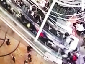 Surveillance video shows an escalator in Hong Kong suddenly reverse.