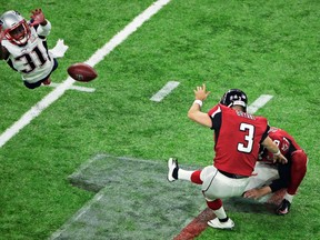 Patriots' Jonathan Jones (left) fails to block an extra point kick by Falcons' Matt Bryant during Super Bowl 51 in Houston. (Charlie Riedel/AP Photo/Files)