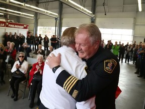 Jason Miller/The Intelligencer
Deputy Chief Ray Ellis gets a farewell hug from his best friend, Quinte West Fire Chief, John Whalen, during Ellis' retirement party on Tuesday.
