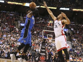 Raptors guard Norman Powell (right) contests Magic forward Terrence Ross' (left) shot during NBA action in Toronto on Monday, March 27, 2017. (Veronica Henri/Toronto Sun)