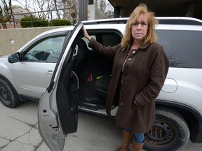 Sue Porter shows the backseat of her van, from which her daughter?s laptop and some personal items were stolen. (MORRIS LAMONT, The London Free Press)