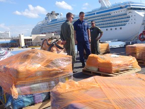 U.S. Coast Guard personnel prepare to offload cocaine from the Coast Guard Cutter James, Tuesday, March 28, 2016, at Port Everglades in Fort Lauderdale, Fla. The drugs were seized along Central and South America by the U.S. Coast Guard and HMCS Saskatoon, which joined the operation in February. (AP PHOTO)