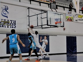 Jeremy Smith (11) grabs a rebound as the St. Francis Xavier Rams move toward a medal in the recent top-tier Alberta high school basketball finals. Looking on are members of the Bishop McNally Wolves, who won 62-57 and went on to defeat Cardston in the final. Fortunately, the Rams gathered themselves for a 75-66 victory over Calgary’s Sir Winston Churchill Bulldogs and came home with bronze. (Supplied)