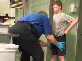 A TSA agent pats-down a boy at a Texas airport.