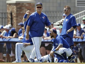 Toronto Blue Jays manager John Gibbons shares a laugh with some of his players before the start of a spring training baseball game against the Detroit Tigers, Wednesday, March 22, 2017, in Dunedin, Fla. (AP Photo/Chris O'Meara)