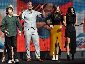 "Baywatch" cast members Zac Efron, from left, Jon Bass, Dwayne Johnson, Alexandra Daddario and Priyanka Chopra interact with the audience during the Paramount Pictures presentation at CinemaCon 2017 at Caesars Palace on Tuesday, March 28, 2017, in Las Vegas. Behind Bass in the photo is cast member Kelly Rohrbach. (Chris Pizzello/Invision/AP)