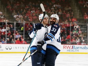 NEWARK, NJ - Joel Armia #40 of the Winnipeg Jets is congratulated by Dustin Byfuglien #33 after scoring the tying goal in the third period against the New Jersey Devils on March 28, 2017 at the Prudential Center in Newark, New Jersey. The Jets defeated the Devils 4-3 in a shootout.
