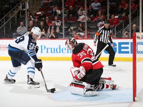 NEWARK, NJ - Patrik Laine #29 of the Winnipeg Jets skates with the puck on his way to scoring the game winning goal during the shootout against Cory Schneider #35 of the New Jersey Devils on March 28, 2017 at the Prudential Center in Newark, New Jersey. The Jets defeated the Devils 4-3 in a shootout.