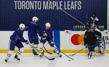 Toronto Maple Leafs  Martin Marincin (52) Alexey Marchenko (18) and Ben Smith (3) fight for the puck along the boards as they worked out as part of the optional skate in preparation for their final three-game road trip of the season which starts Thursday against the Nashville Predators on Wednesday March 29, 2017. Jack Boland/Toronto Sun/Postmedia Network